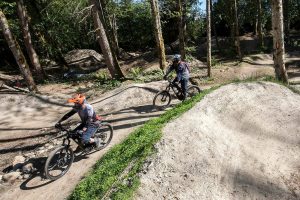 A pair of bikers ride past the new Mukilteo Bike Park on Wednesday, June 12, 2024 in Mukilteo, Washington. (Olivia Vanni / The Herald)