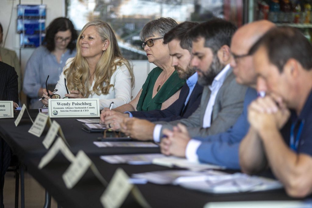 Attendees listen during a roundtable discussion at the Paine Field Airport Maintenance Department in Everett, Washington on Thursday, June 6, 2024. Members of the industry discussed how the FAA Reauthorization bill, signed into law last month, is expected to benefit Paine Field. (Annie Barker / The Herald)