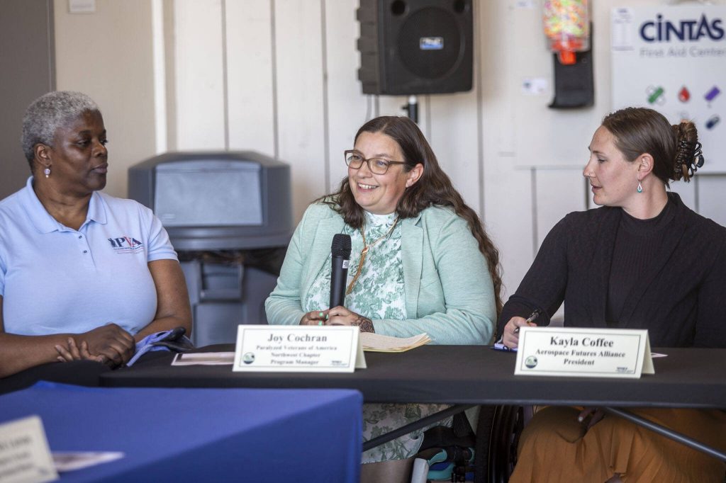 Paralyzed Veterans of America northwest chapter program manager Joy Cochran speaks during a roundtable discussion at the Paine Field Airport Maintenance Department in Everett, Washington on Thursday, June 6, 2024. Members of the industry discussed how the FAA Reauthorization bill, signed into law last month, is expected to benefit Paine Field. (Annie Barker / The Herald)