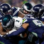 Eagles quarterback Jalen Hurts gets stopped by Seattle Seahawks defensive end Leonard Williams (99) and linebacker Bobby Wagner (54) on Dec. 18, 2023, at Lumen Field in Seattle. (Yong Kim / The Philadelphia Inquirer, file)