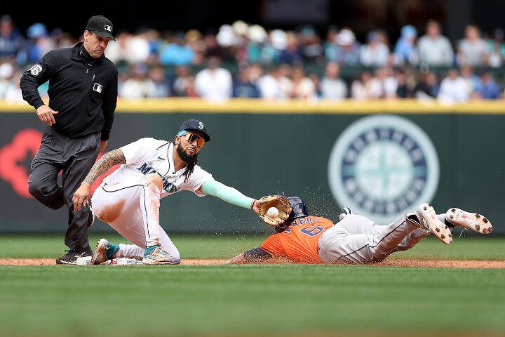 Shortstop J.P. Crawford (3) tags out Jake Meyers (6) of the Houston Astros on May 30 at T-Mobile Park in Seattle. (Steph Chambers / Getty Images, file)
