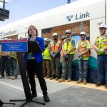 Lynnwood Mayor Christine Frizzell addresses a platform full of press, officials and construction workers during a press event at the Lynnwood City Center Link Station on Friday, June 7, 2024, in Lynnwood, Washington. (Ryan Berry / The Herald)