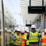 Construction crew members stand together while attending a press event at the Lynnwood City Center Link Station on Friday, June 7, 2024, in Lynnwood, Washington. (Ryan Berry / The Herald)