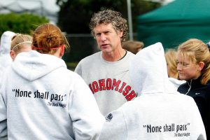 Dan Parker with the Snohomish High School girls cross country team. (Elizabeth Armstrong / The Herald)