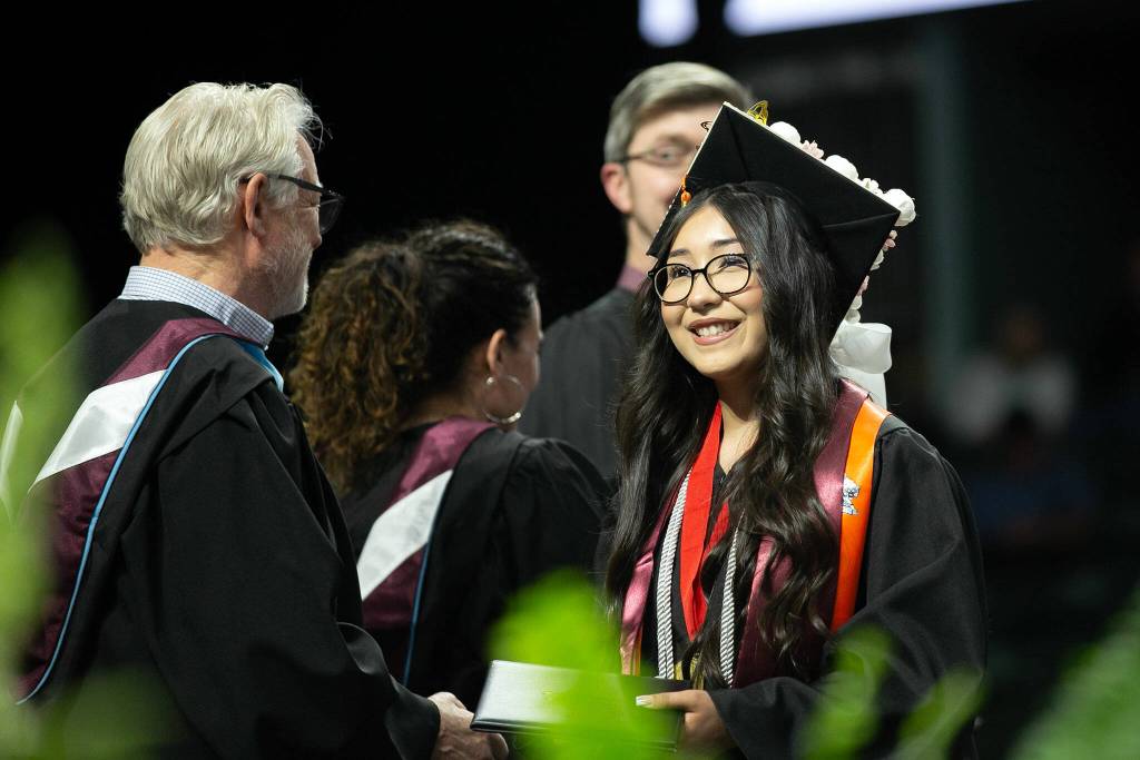 Students begin to cross the stage and receive their diplomas during Monroe High Schools 2024 commencement on Wednesday, June 12, 2024, at Angel of the Winds Arena in Everett, Washington. (Ryan Berry / The Herald)