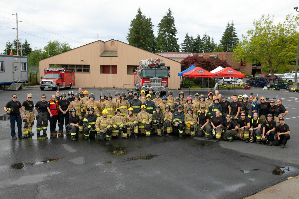 A team of over 50 female instructors and workshop participants gather for a group photo during the Future Women in EMS/Fire Workshop on Saturday, June 22, 2024, at the South County Fire Training Center in Everett, Washington. (Ryan Berry / The Herald)