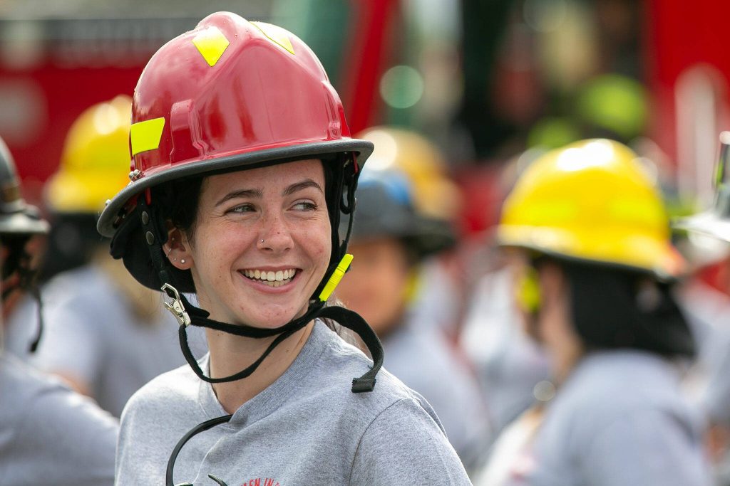 Potential recruits, including Audrey Froelich, excitedly line up before the start of a demonstration during the Future Women in EMS/Fire Workshop on Saturday, June 22, 2024, at the South County Fire Training Center in Everett, Washington. (Ryan Berry / The Herald)