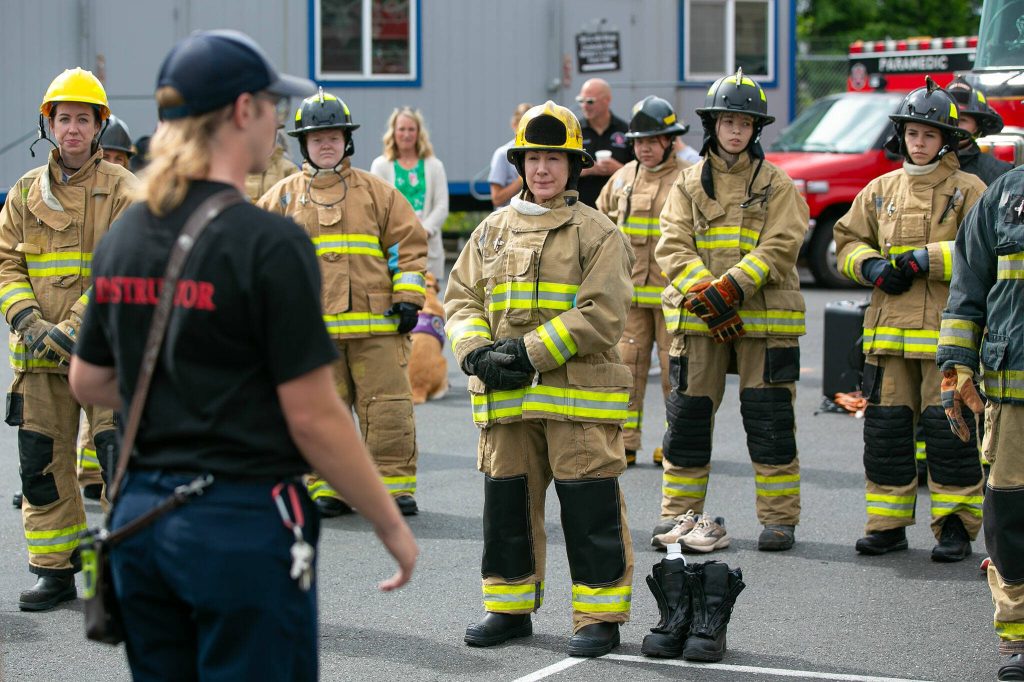 Attendees listen to instructions before breaking off to different workshops during the Future Women in EMS/Fire Workshop on Saturday, June 22, 2024, at the South County Fire Training Center in Everett, Washington. (Ryan Berry / The Herald)