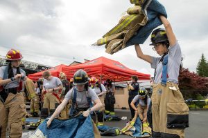Firefighter hopefuls suit up during the Future Women in EMS/Fire Workshop on Saturday, June 22, 2024, at the South County Fire Training Center in Everett, Washington. (Ryan Berry / The Herald)