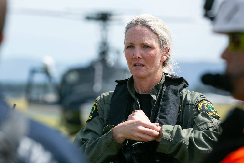 Jen Stollwerck, pilot for Snohomish County Volunteer Search and Rescue, speaks with a group of volunteers during an interagency training session held by Northwest Regional Aviation on Thursday, June 13, 2024, at the Arlington Airport in Arlington, Washington. (Ryan Berry / The Herald)