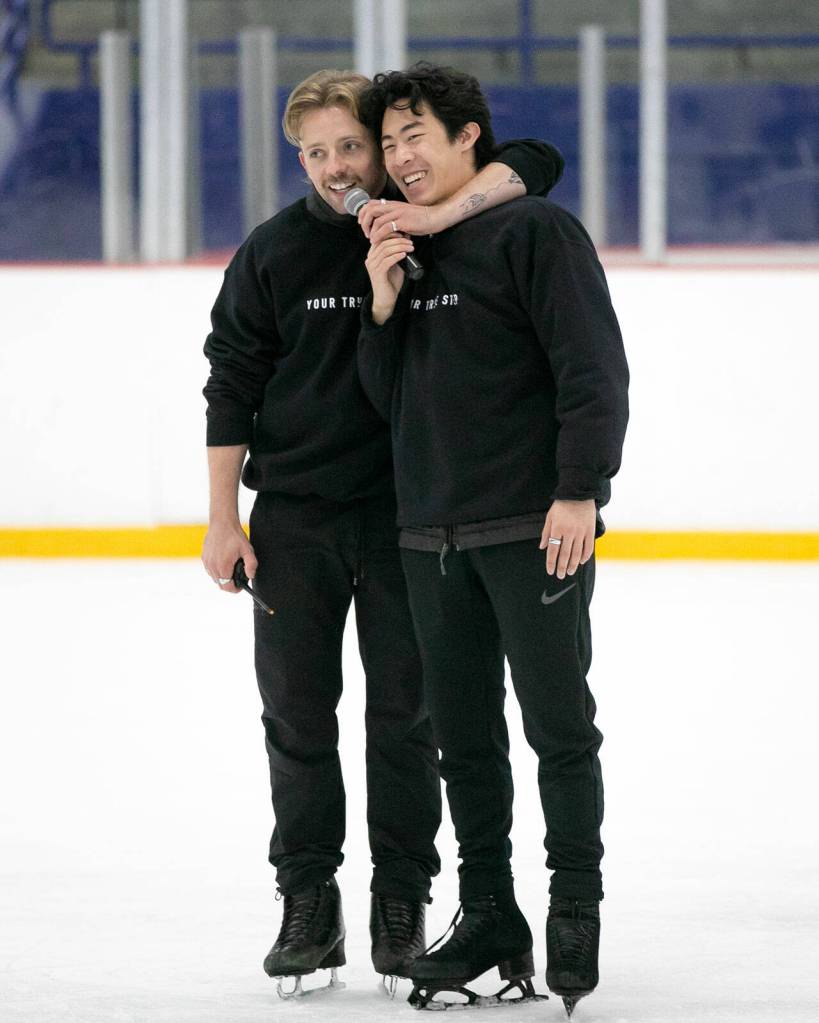 Jean-Luc Baker, left, throws his arm around Nathan Chen as the two speak to a class during the Seattle Skating Club 2024 Your True Step figure skating seminar on Saturday, June 15, 2024, at Olympic View Arena in Mountlake Terrace, Washington. (Ryan Berry / The Herald)