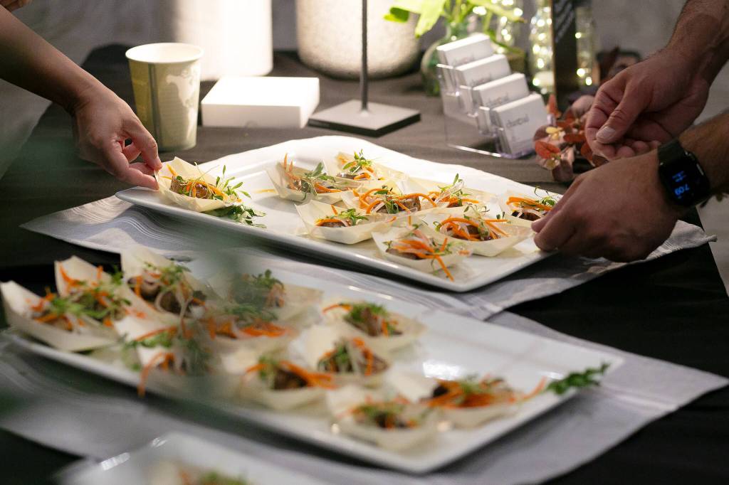 Charcoal’s grilled pork belly with fish sauce caramel, pickled carrot and daikon slaw steals the show at Crave! Northwest food festival at the Lynnwood Event Center on Friday, June 21, 2024, in Lynnwood, Washington. (Ryan Berry / The Herald)