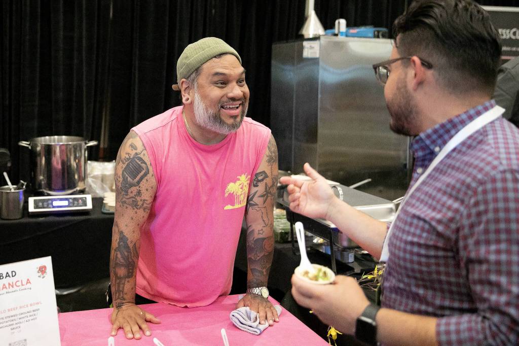 Jose Garzon of Bad Chancla chats it up at Crave! Northwest food festival at the Lynnwood Event Center on Friday, June 21, 2024, in Lynnwood, Washington. (Ryan Berry / The Herald)