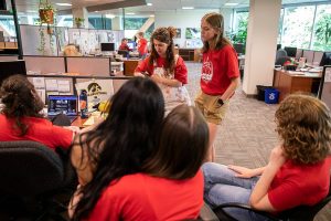 Everett Herald staff gather and talk in the newsroom after layoff announcements on Wednesday, June 19, 2024 in Everett, Washington. (Olivia Vanni / The Herald)