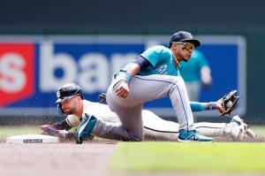 Seattle Mariners second baseman Jorge Polanco (right) tries to put the tag down on the Minnesota Twins baserunner Edouard Julien at Target Field on Thursday, May 9, 2024, in Minneapolis. (David Berding / Getty Images)