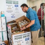 Robert Fabia, a sales manger at Lee Johnson Hyundai of Everett, shows some of the donations they have received on Tuesday, June 25, 2024 in Everett, Washington. (Olivia Vanni / The Herald)