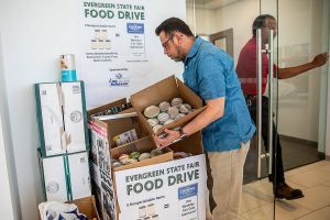 Robert Fabia, a sales manger at Lee Johnson Hyundai of Everett, shows some of the donations they have received on Tuesday, June 25, 2024 in Everett, Washington. (Olivia Vanni / The Herald)