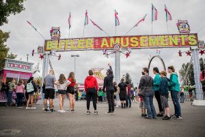 People wait in line for amusement park tickets during opening day of the Evergreen State Fair on Thursday, Aug. 26, 2021, in Monroe, Washington. (Olivia Vanni / The Herald)
