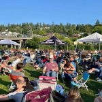 People kick back in their lawn chairs while listening to live music at Mukilteos Lighthouse Park during a previous years Music at the Beach event. This years concert series begins June 29. (Photo courtesy of the Mukilteo Chamber of Commerce)