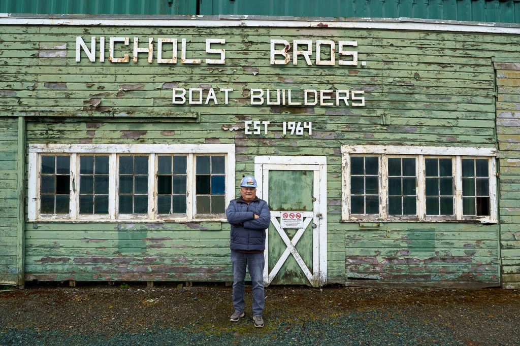 Nichols poses in front of an original building at the Freeland site. (Photo by David Welton)