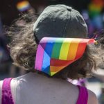 A person wears a pride flag in their hat during the second annual Arlington Pride at Legion memorial Park in Arlington on Saturday, July 22, 2023. (Annie Barker / The Herald file photo)