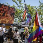 Protesters and attendees interact during the second annual Arlington Pride at Legion memorial Park in Arlington, Washington on Saturday, July 22, 2023. (Annie Barker / The Herald)