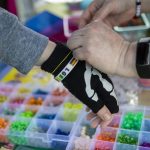 People participate in making bracelets during the third annual Arlington Pride event in Arlington, Washington on Sunday, June 2, 2024. (Annie Barker / The Herald)