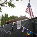 Pride and American flags are displayed during the third annual Arlington Pride event in Arlington, Washington on Sunday, June 2, 2024. (Annie Barker / The Herald)