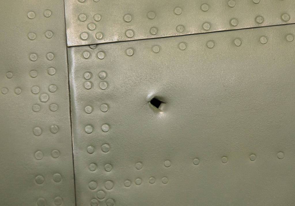 A bullet hole is visible on the side of a Nakajima KI-43-IB (Oscar) at the Flying Heritage & Combat Armor Museum on Friday, March 29, 2024 in Everett, Washington. (Olivia Vanni / The Herald)