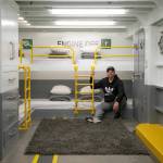 Homeowner Ryan Anderson sits on the bunk beds in the ferry quarters at Ferry Cove, the latest feature in the 5-bedroom waterfront vacation rental in Clinton. (Ryan Berry / The Herald)