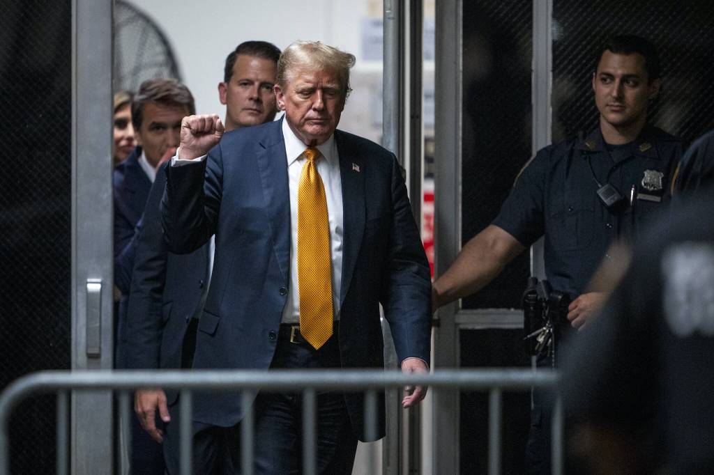 Former President Donald Trump raises a fist as he walks to the courtroom after the jury had a question for the judge amid deliberations in his criminal trial at the New York State Supreme Court in Manhattan, Wednesday, May 29, 2024. (Doug Mills/The New York Times)