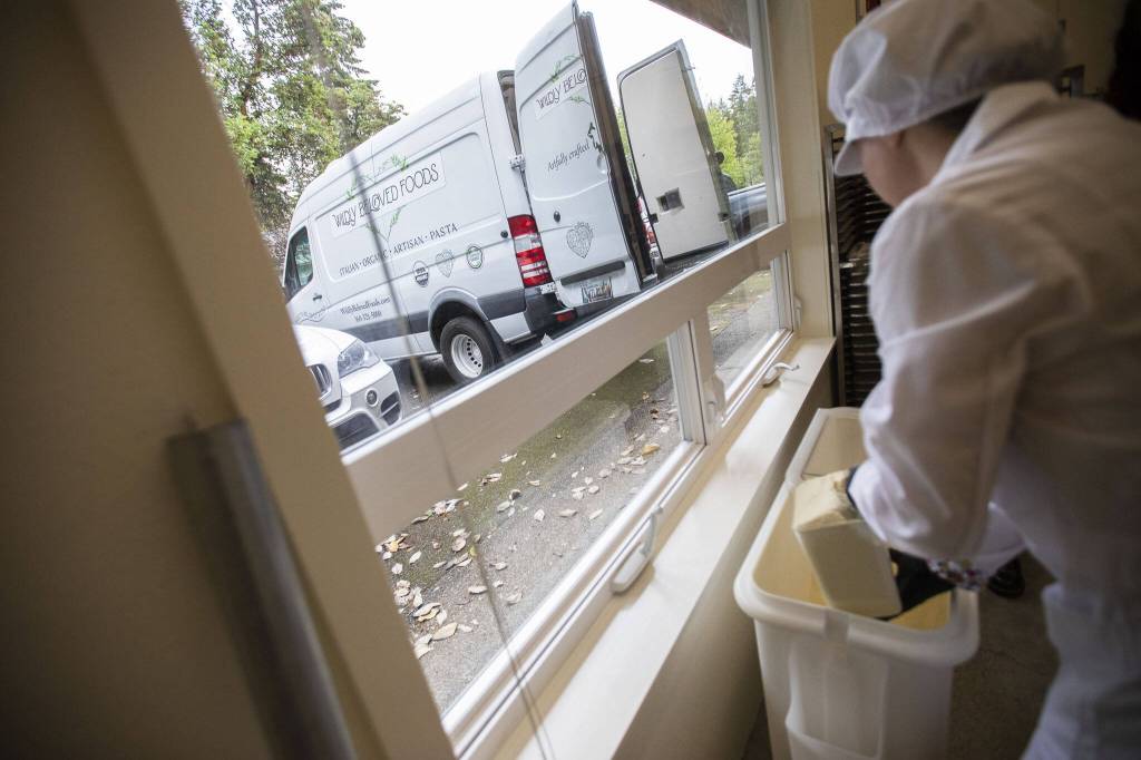Pasta is loaded into a truck at Wildly Beloved Foods on Thursday, June 27, 2024 in Clinton, Washington. (Olivia Vanni / The Herald)
