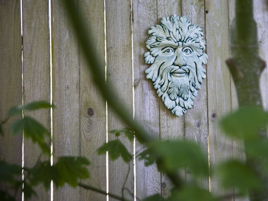 A pottery mask hangs on a fence on Tuesday, July 2, 2024 in Mukilteo, Washington. (Olivia Vanni / The Herald)