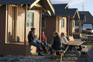Guests enjoy the sunset and wind Friday afternoon at Cama Beach Historical State Park on Camano Island on October 25, 2019. (Kevin Clark / The Herald)