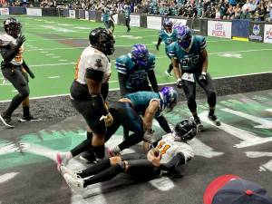 Washington Wolfpack defensive lineman DeShon Williams sacks Wichita Regulators quarterback Joseph Hess as Marcus Pressley (75) and former Jackson High School football player Jonathan Navarro (52) begin to celebrate in an Arena Football League game at Angel of the Winds Arena in Everett on June 29, 2024. (Aaron Coe / The Herald).