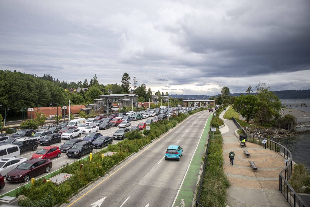People and cars board and exit the Mukilteo ferry in Mukilteo, Washington on Monday, June 3, 2024. (Annie Barker / The Herald)