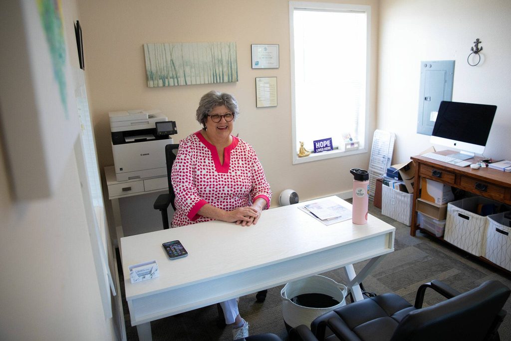 Robin Sparks sits in her humble office space at the C-Suite Center for Hope on Wednesday, July 3, 2024, in Marysville, Washington. The room at Jennings Park offers Sparks and her clients a home base for C-Suites work. (Ryan Berry / The Herald)