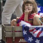 A child rides in a wagon during the Fourth of July parade in downtown Everett, Washington, on Tuesday, July 4, 2023. (Annie Barker / The Herald)