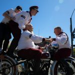 The Seattle Cossacks Motorcycle Stunt Team pile onto a motorcycle during Everetts Fourth of July Parade on Thursday, July 4, 2024, in downtown Everett, Washington. (Ryan Berry / The Herald)