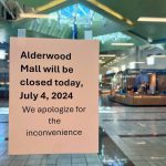 A sign seen from inside Macy's informs customers that the Alderwood Mall is closed on Thursday, July 4, 2024, in Lynnwood, Washington (Andrea Brown / The Herald)