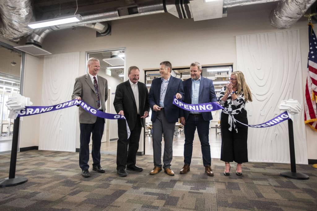 Prosecuting Attorney Jason Cummings (left to right), Snohomish County Executive Dave Somers, Snohomish County Auditor Garth Fell, Snohomish County Councilmember Sam Low and League of Women Voters President-Elect Adrienne Fraley cut the ribbon of the new Elections Center on Tuesday, July 9, 2024 in Everett, Washington. (Olivia Vanni / The Herald)