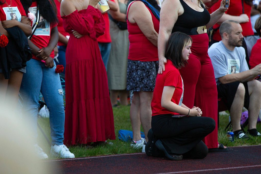 People listen to a prayer during a vigil held in memory of Jayda Woods-Johnson at Mountlake Terrace High School on Sunday, July 7, 2024, in Mountlake Terrace, Washington. (Ryan Berry / The Herald)