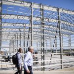 People walk past the construction of a new building at the Helion campus on Tuesday, July 9, 2024, in Everett, Washington. (Olivia Vanni / The Herald)