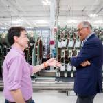 Gov. Jay Inslee laughs while talking with Helion Energy CEO and co-founder David Kirtley on Tuesday, July 9, 2024, in Everett, Washington. (Olivia Vanni / The Herald)