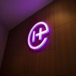 A bright pink Helion logo lights up the lobby on Tuesday, July 9, 2024, in Everett, Washington. (Olivia Vanni / The Herald)