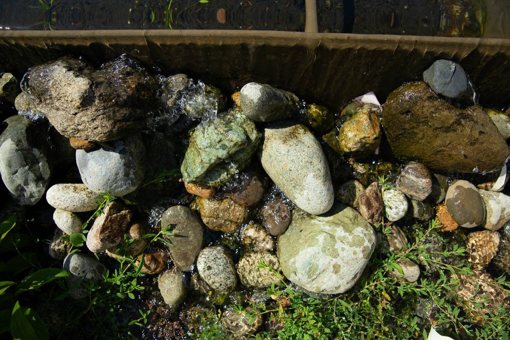 Stormwater spills out onto the landscape at the downtown Marysville stormwater treatment plant on Thursday, July 11, 2024, in Marysville, Washington. (Ryan Berry / The Herald)