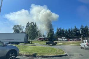 A house fire sends a column of smoke into the air, as seen from Olympic View Middle School, on Monday, July 8, 2024, in Mukilteo, Washington. (Jenelle Baumbach / The Herald)