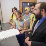 Members of Everett Deserves a Raise group turn in their signed patients to the the clerk at City Hall on Thursday, July 11, 2024 in Everett, Washington. (Olivia Vanni / The Herald)