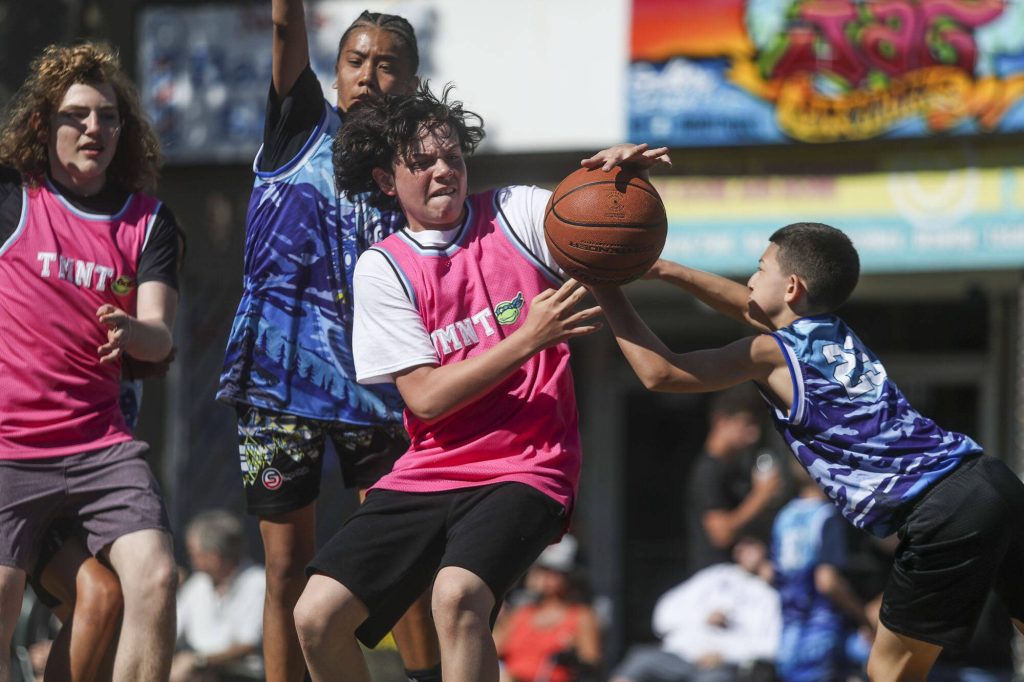 TMNT players and Immortals players compete in the 14-15 year old male bracket during the Everett 3on3 tournament in downtown Everett, Washington on Sunday, July 14, 2024. (Annie Barker / The Herald)