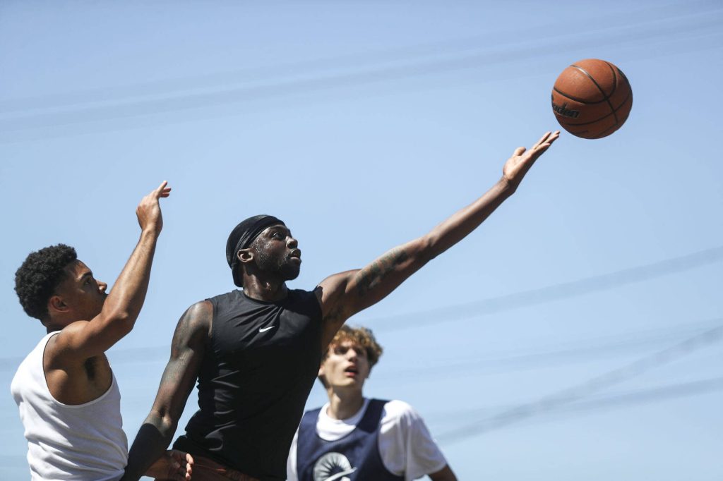 FAB and WeAreEverett face off in the 18 and older mens bracket during the Everett 3on3 tournament in downtown Everett, Washington on Sunday, July 14, 2024. (Annie Barker / The Herald)